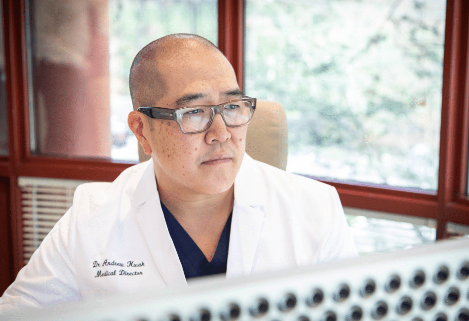 Dr. Kwak looking at computer screen